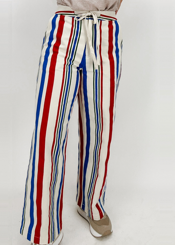 wide leg drawstring pants with vertical red, cream, green, and blue stripes and back pockets