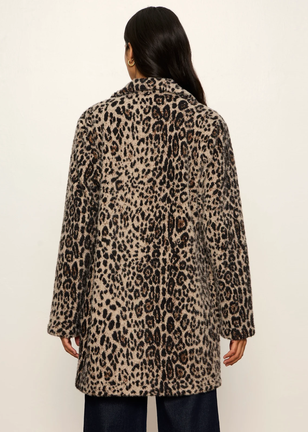 Woman wearing a leopard print coat.