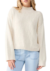 cream mock neck sweater with ribbed collar, hem, and cuffs 