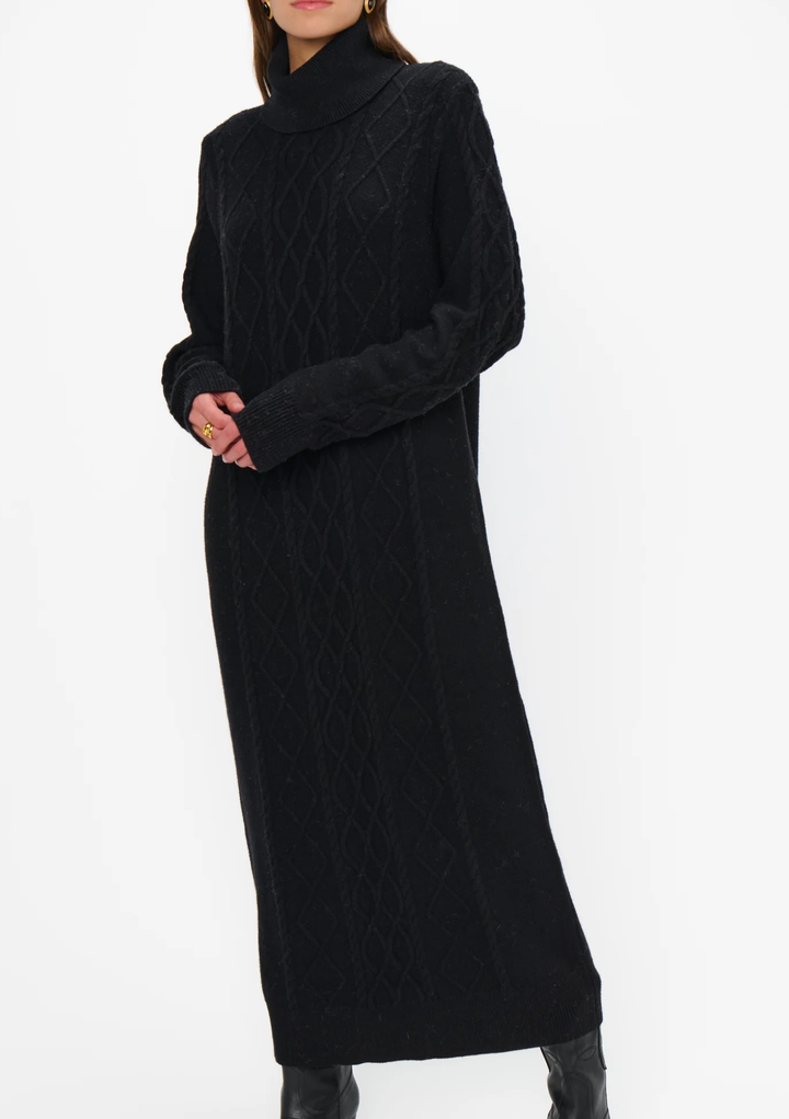Black cable knit dress worn by a person on a white background