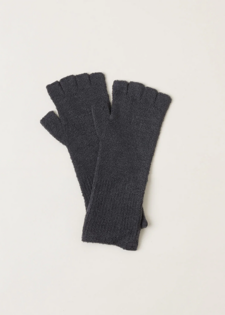 A pair of dark grey fingerless fuzzy gloves laying on a white background