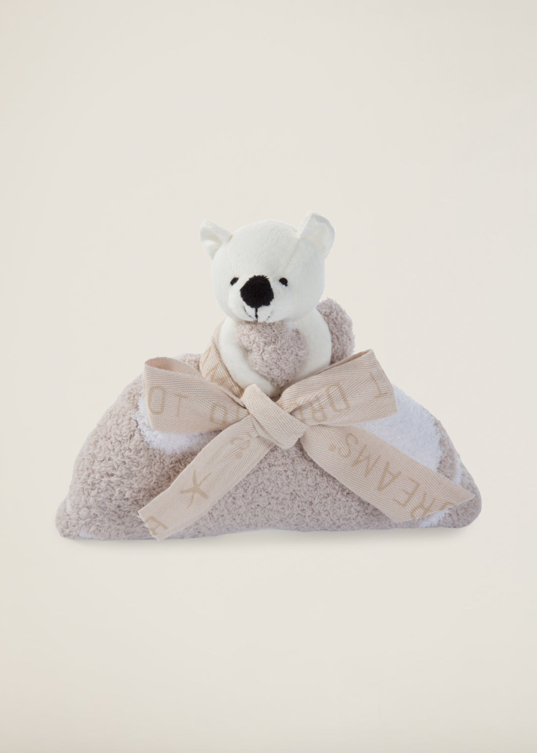 Stuffed animal attached to a brown blanket