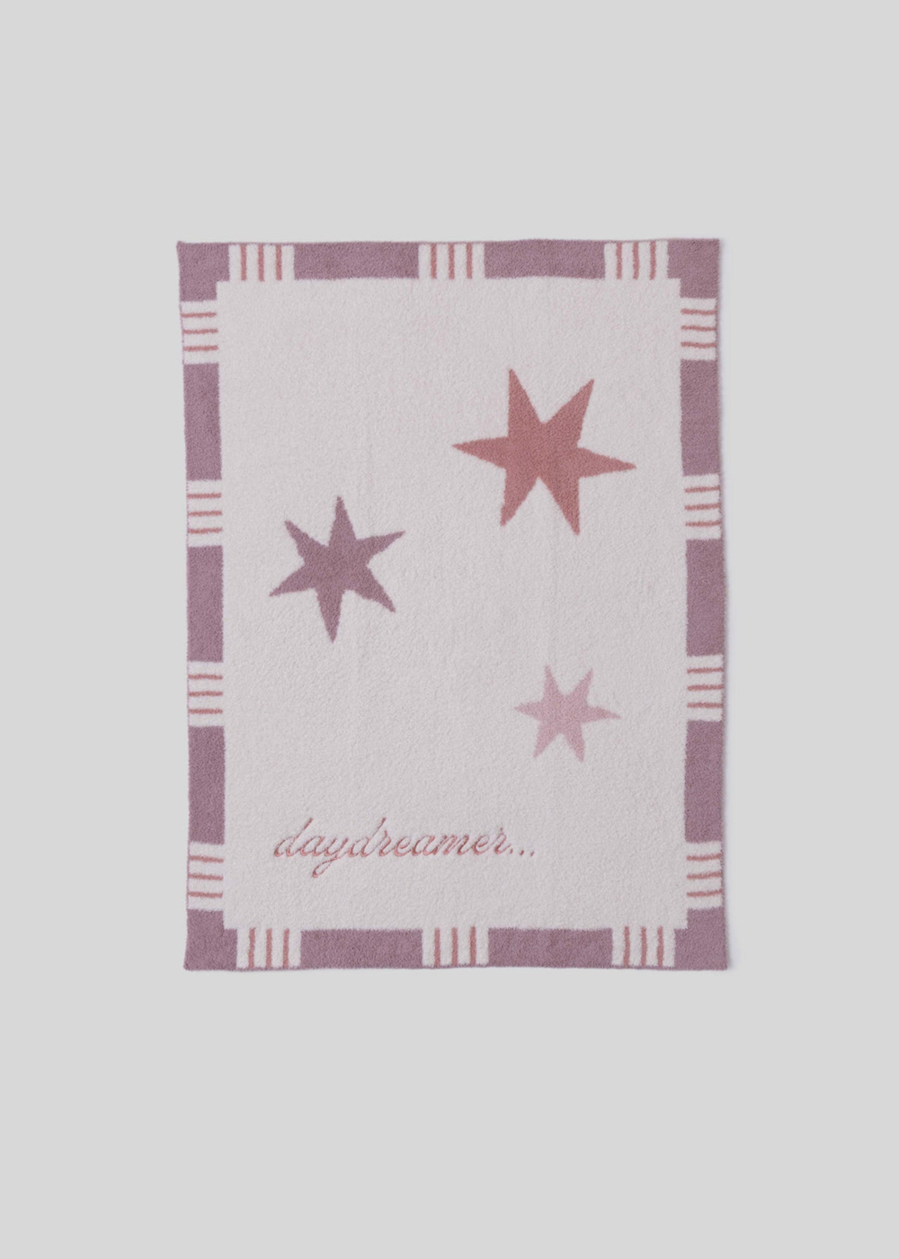 Pink blanket with stars and a striped border and "daydreamer..." pink embroidery