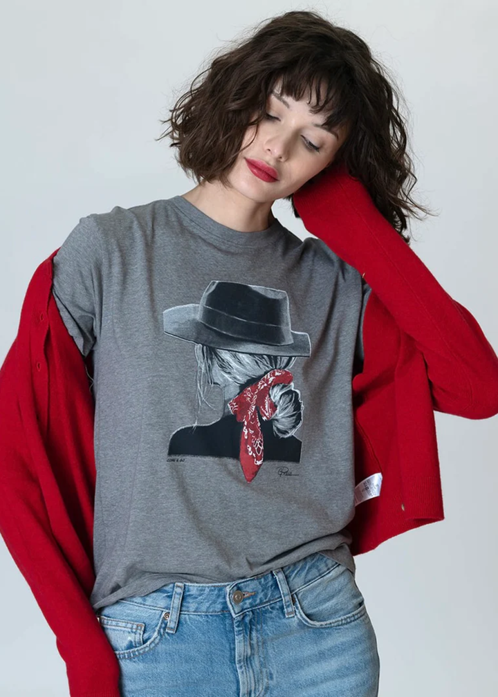 Woman wearing a grey graphic tee with a red cardigan