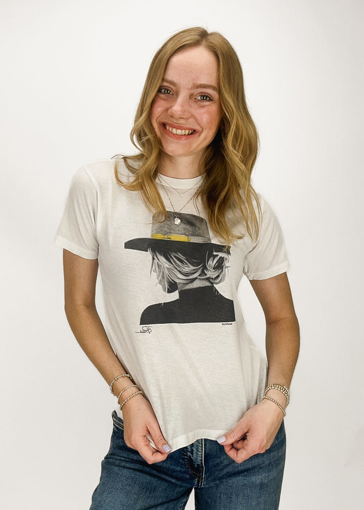 White short sleeve tee with girl wearing messy bun, flat brim hat, and mock neck tee chest graphic