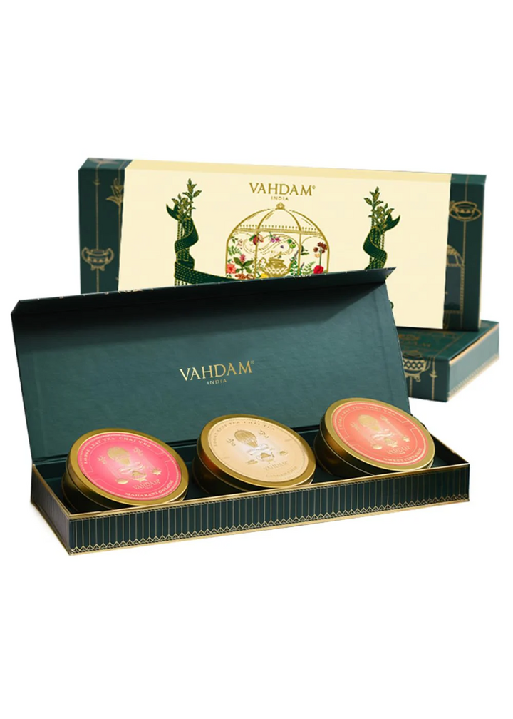 Three chai tea containers in a decorative green and ivory box