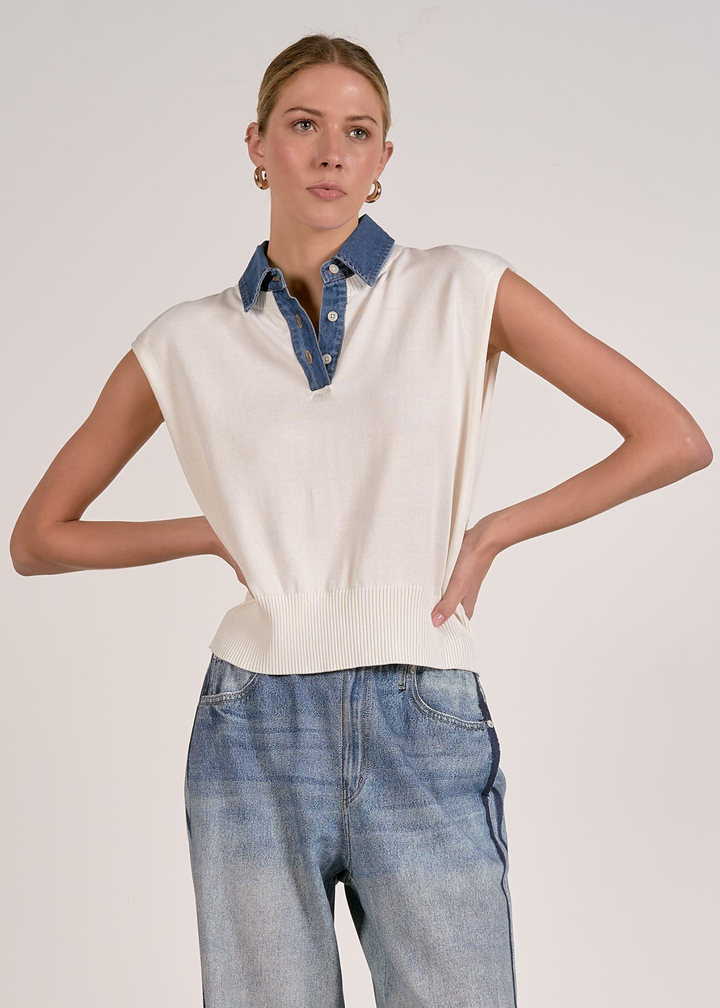 Woman wearing a white knit top with jeans