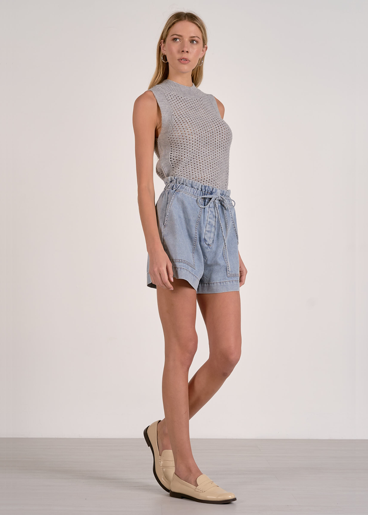 Woman wearing blue shorts with a grey knit tank