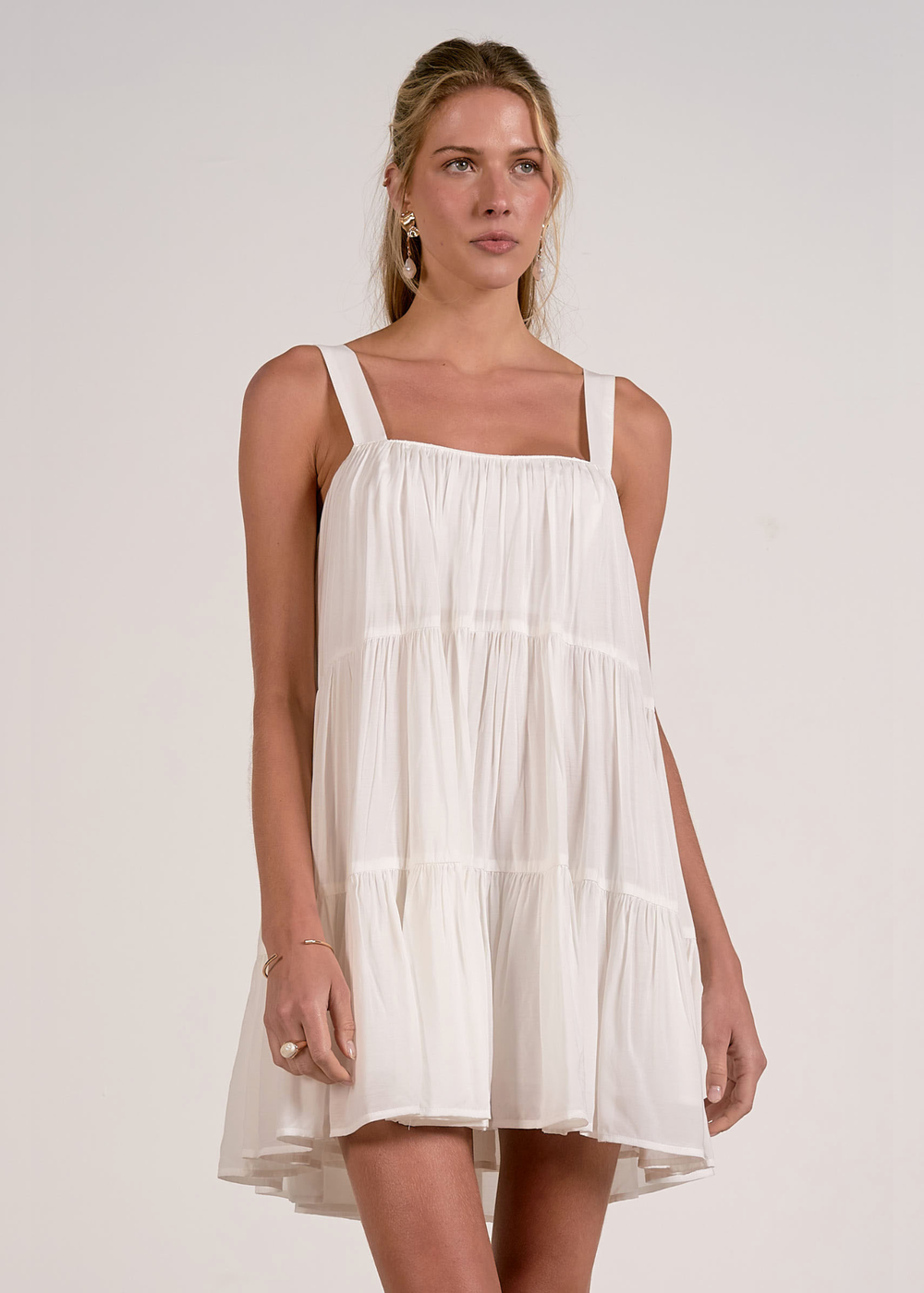 Woman wearing a white tiered mini dress