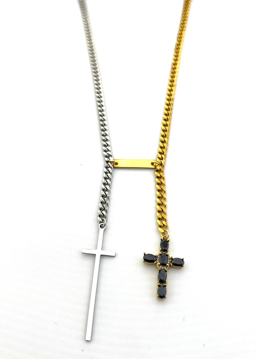 Two toned chain necklace with cross charms on a white background