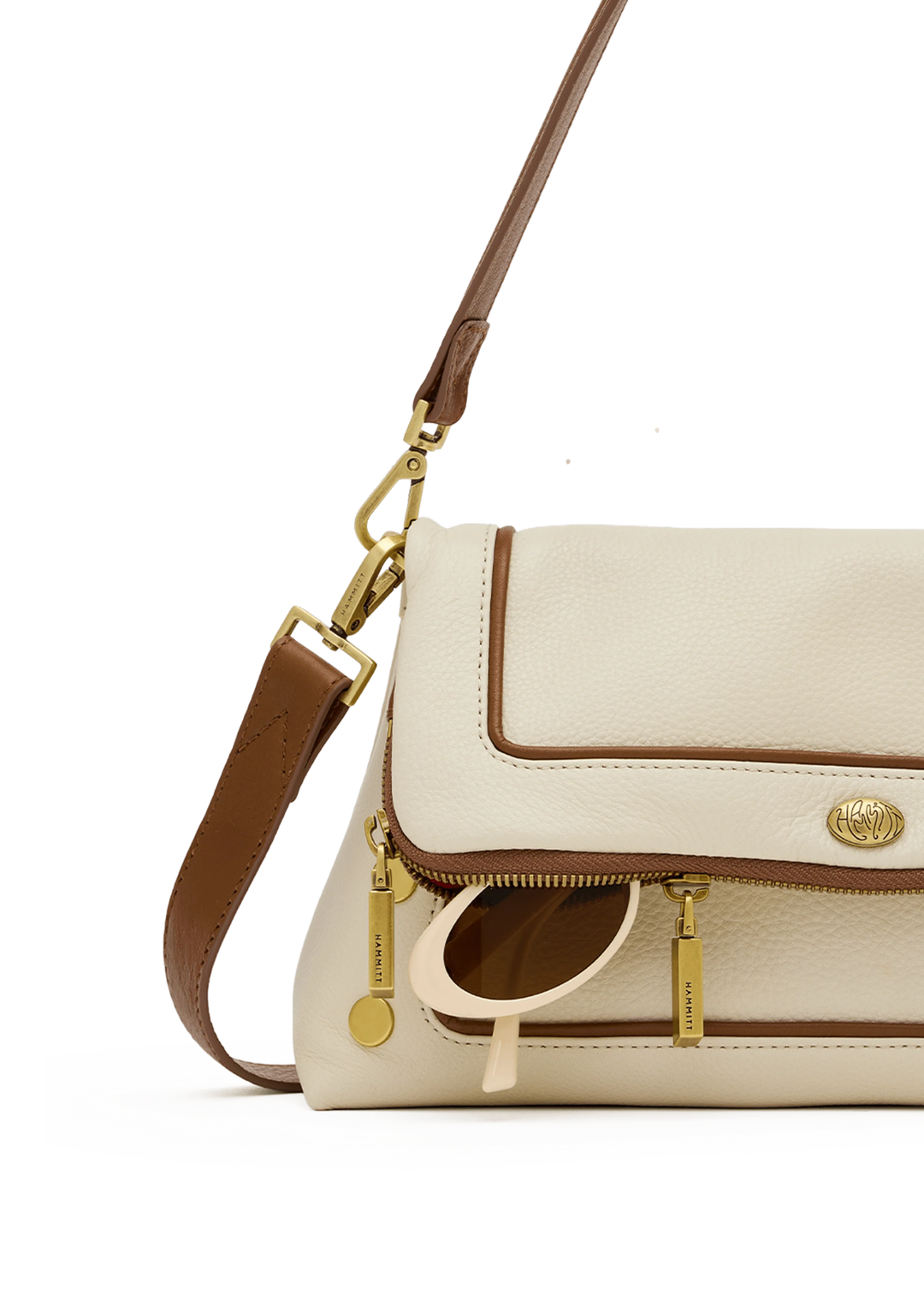 White leather purse with brown trim and gold accents