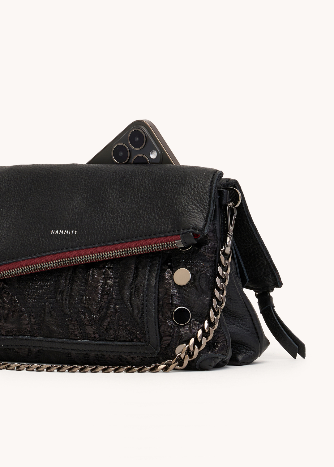 Black handbag with a grey chain on a white background