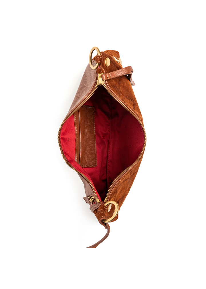 Brown suede and leather purse with gold accents sitting open on a white background