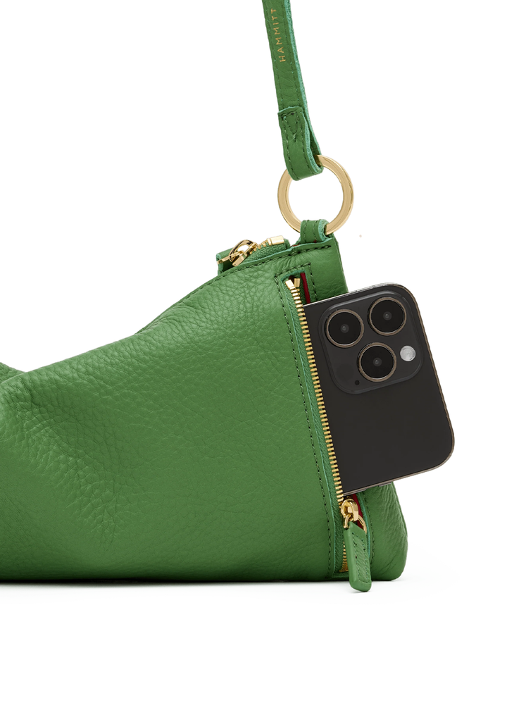 Green handbag with gold hardware on a white background