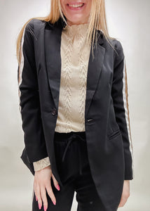 black blazer with tan and white trim down the sleeves