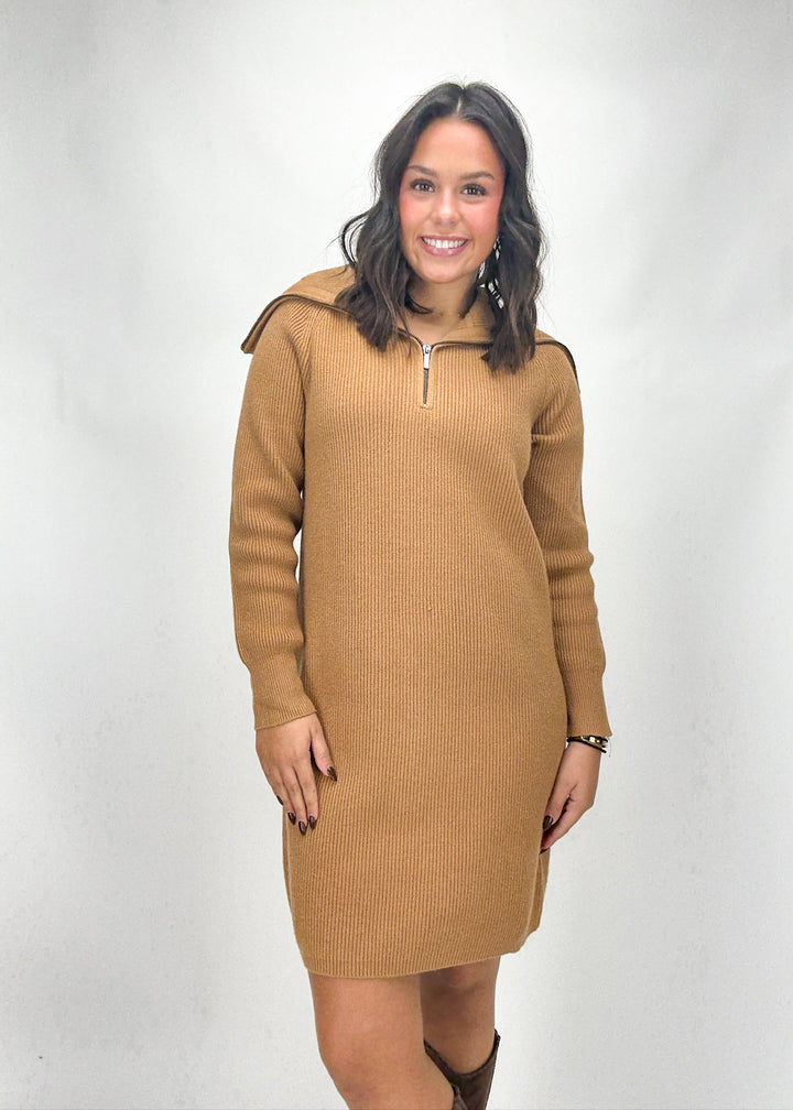 Woman wearing a brown ribbed dress with a zipper on a white background