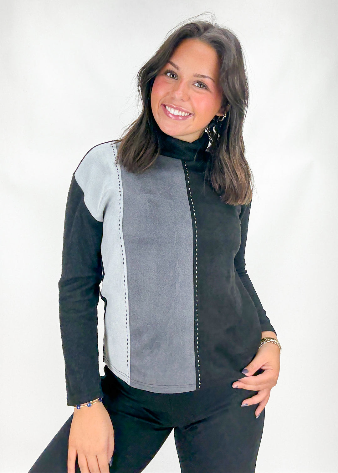 Woman wearing a black and gray jacket on a white background