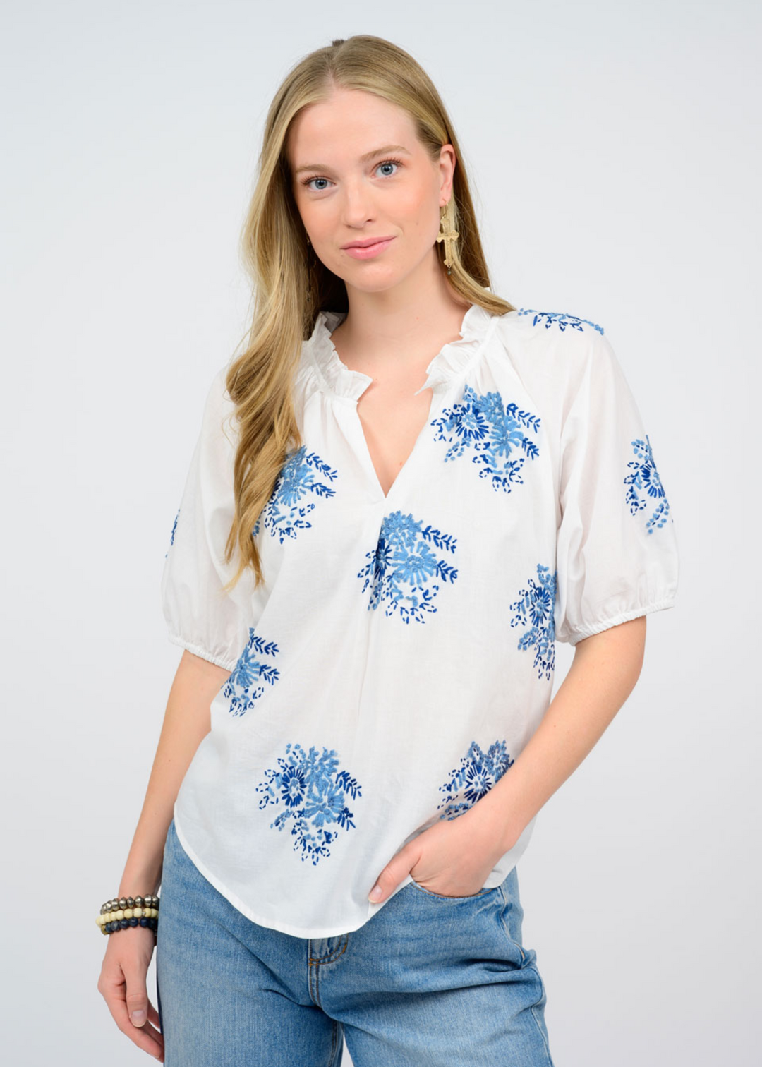 Women's white split-neck ruffle collar top with blue floral print 