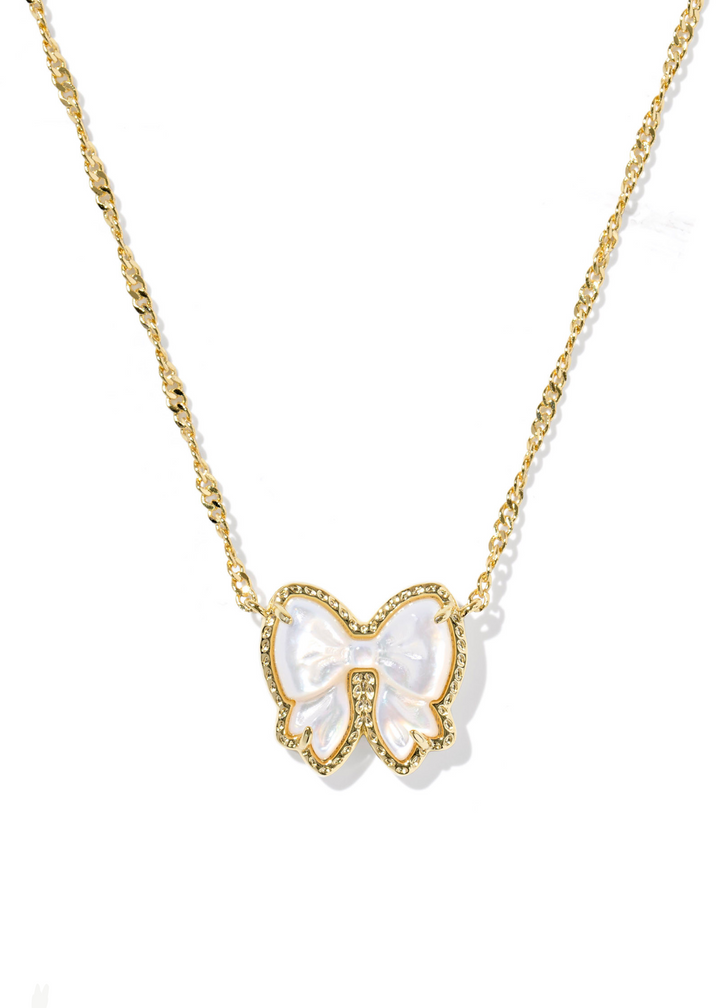 Women's gold necklace with a bow shaped pendant and an ivory mother of pearl stone