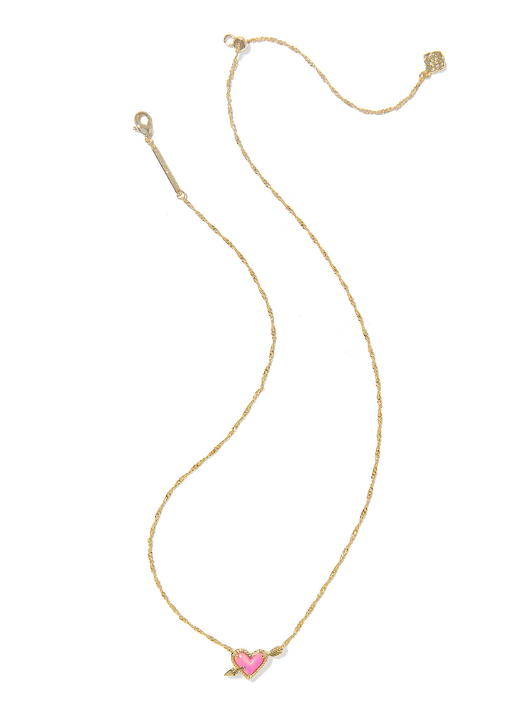 Gold necklace with a pink arrow heart pendant against a white background