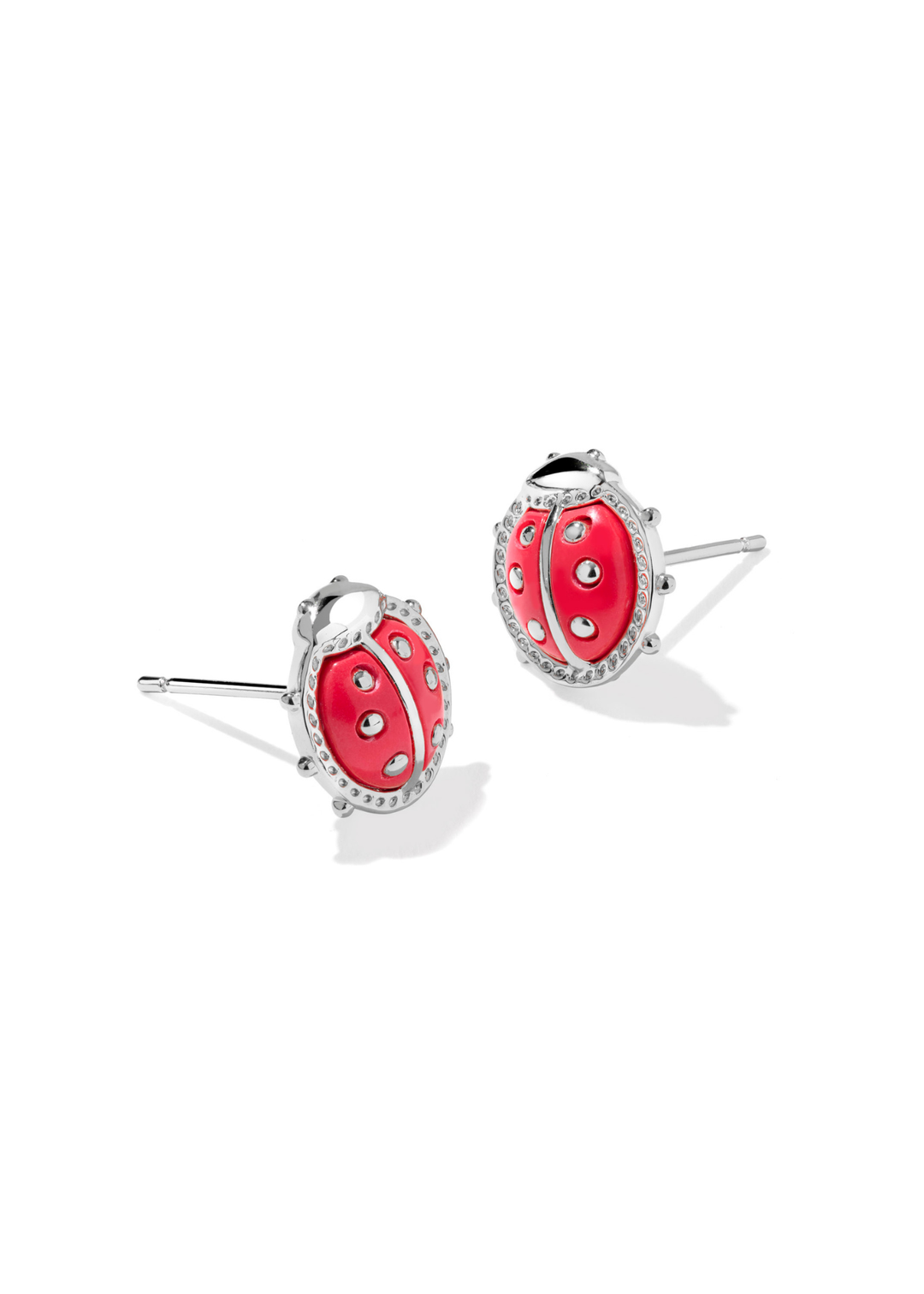 Rhodium framed red ladybug stud earrings on a white background