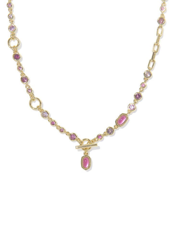 Gold necklace with pink stones against a white background