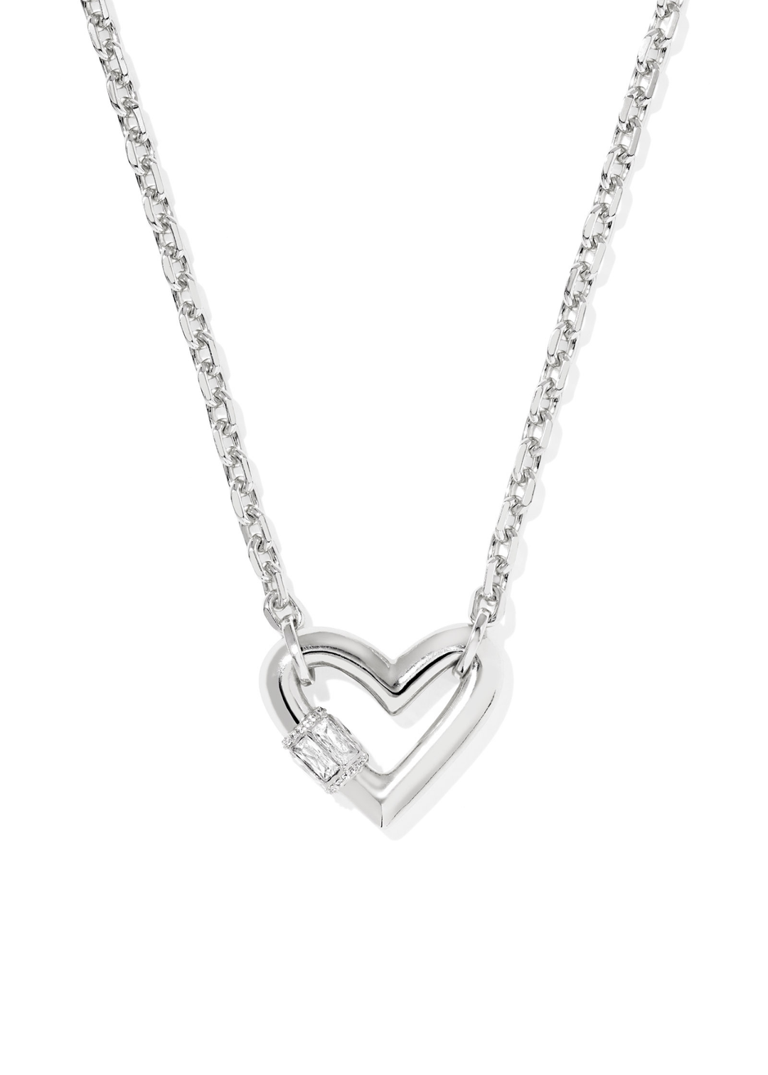 Rhodium necklace with a heart shaped pendant laying on a white background