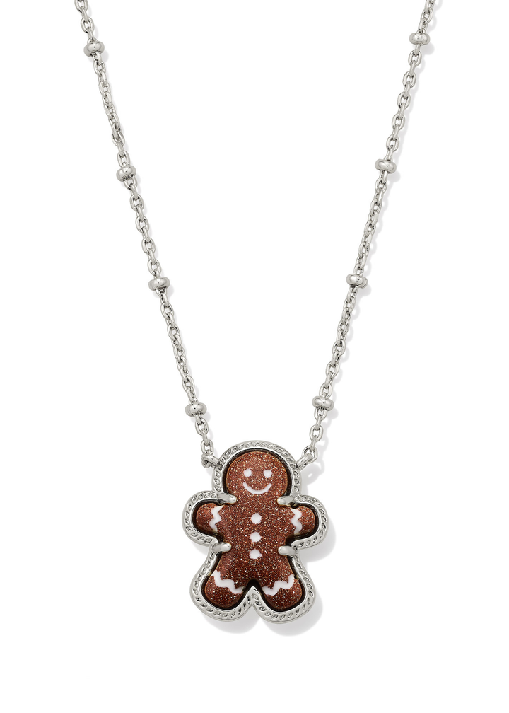 Silver necklace with a brown sparkly gingerbread pendant on a white background