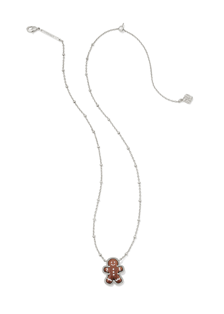 Silver necklace with a brown sparkly gingerbread pendant on a white background