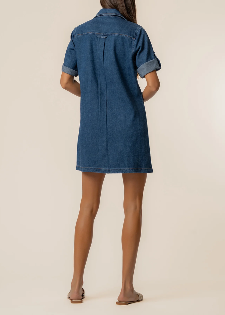 Woman turned around wearing a collared denim mini dress with sandals