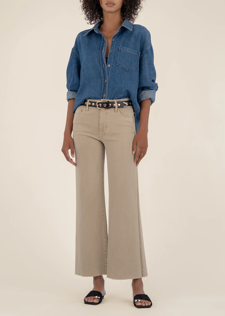 Woman wearing tan wide leg jeans with raw hems and a denim shirt