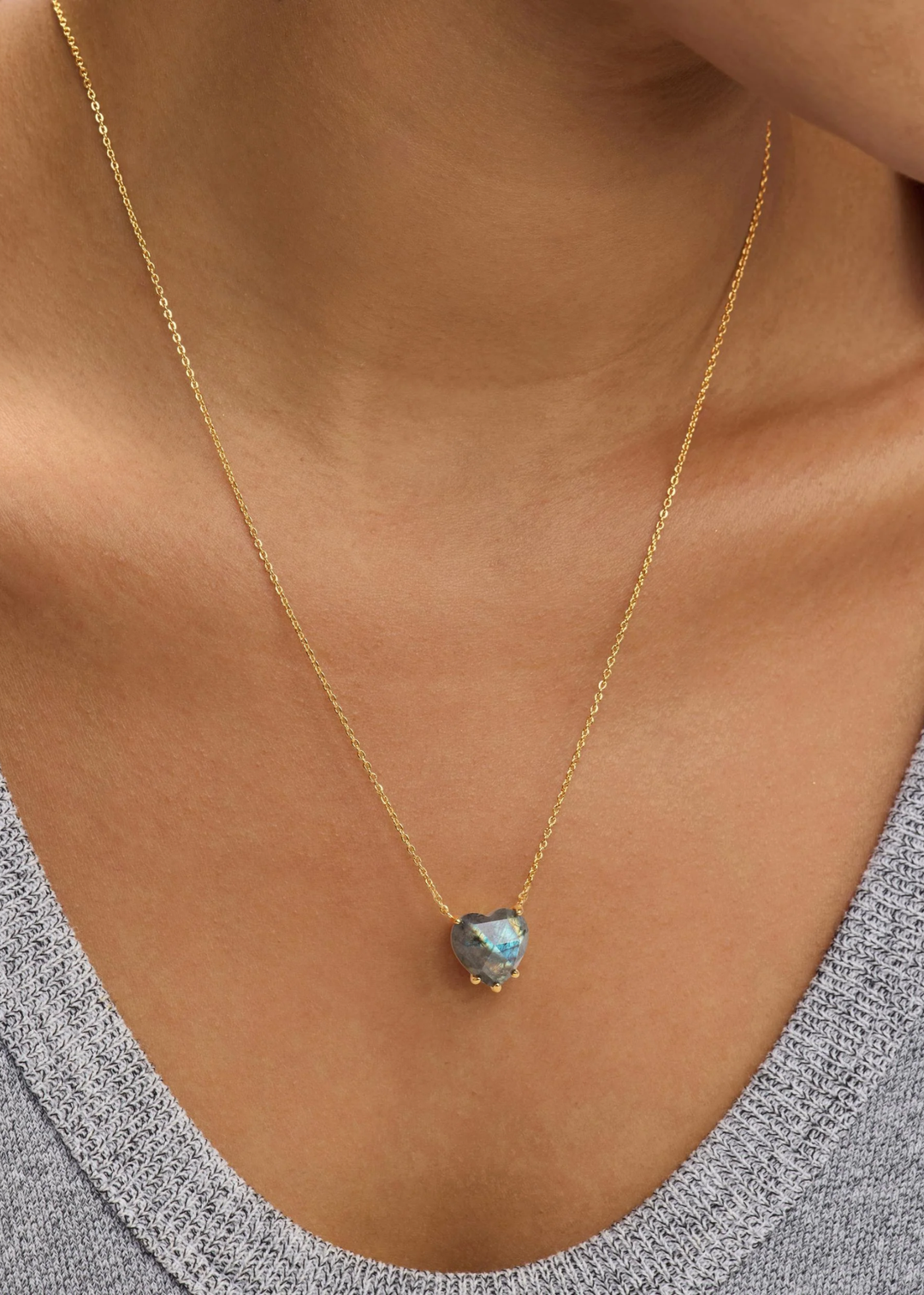 Woman wearing a heart shaped labradorite pendant necklace