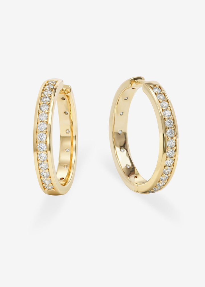 Gold hoop earring with CZ studding against a white background