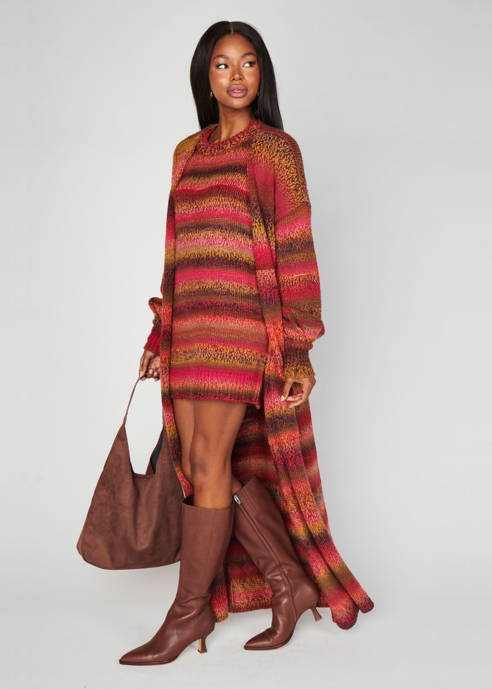 Woman wearing a red and brown striped cardigan in front of a white background