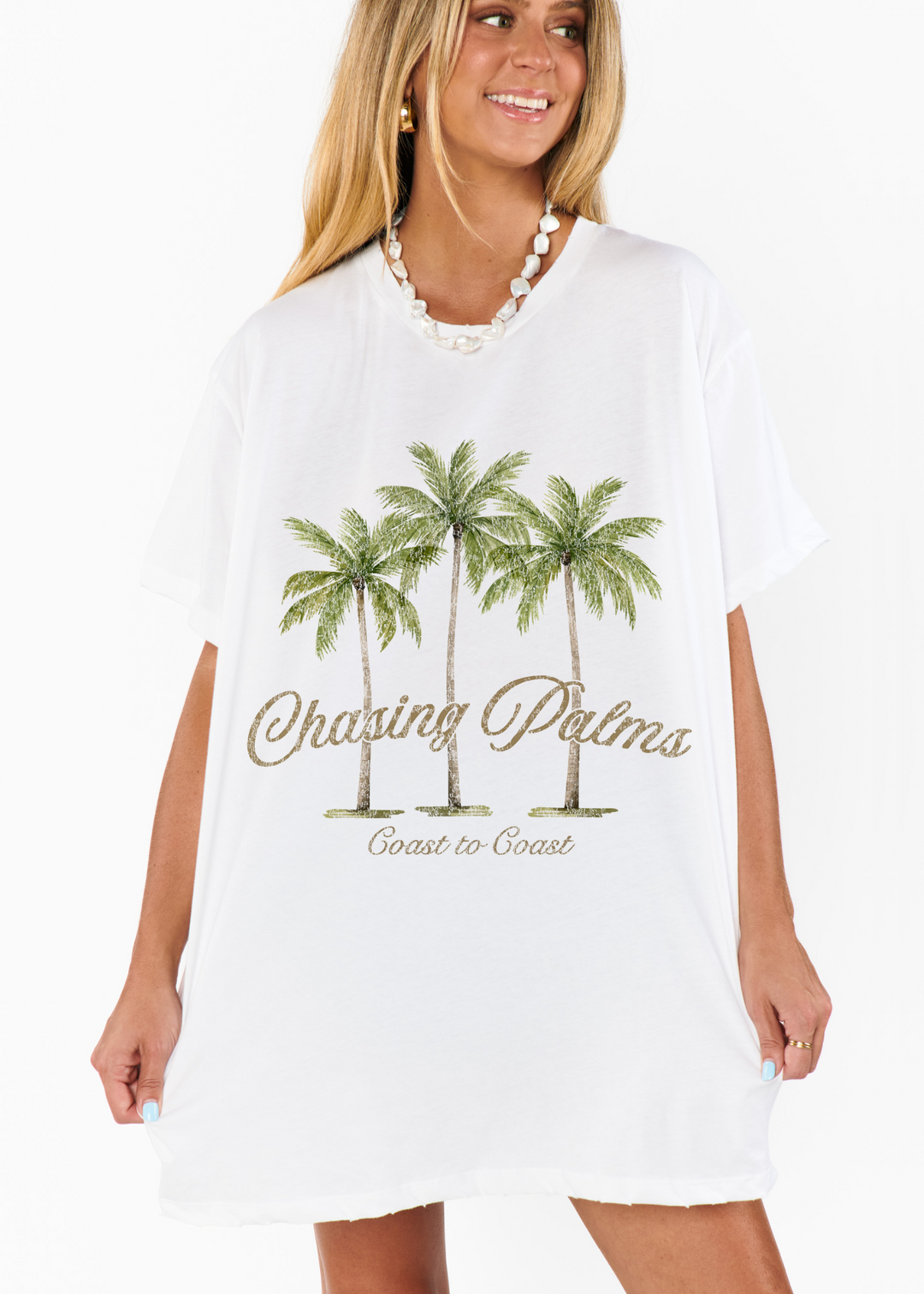Women's white oversized graphic tee with palm trees and "Chasing Palms" graphic
