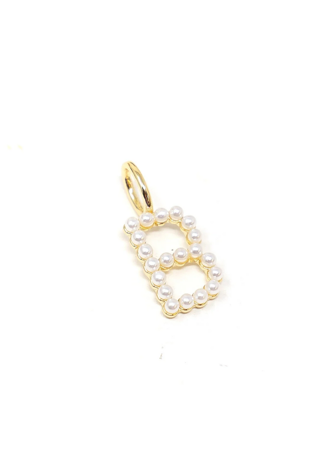 A gold and pearl initial "B" charm on a white background