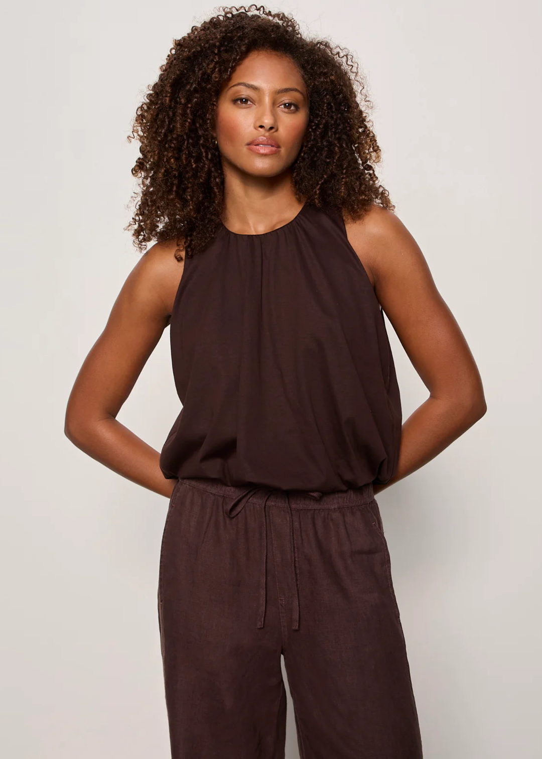 Woman wearing a brown tank top with matching pants