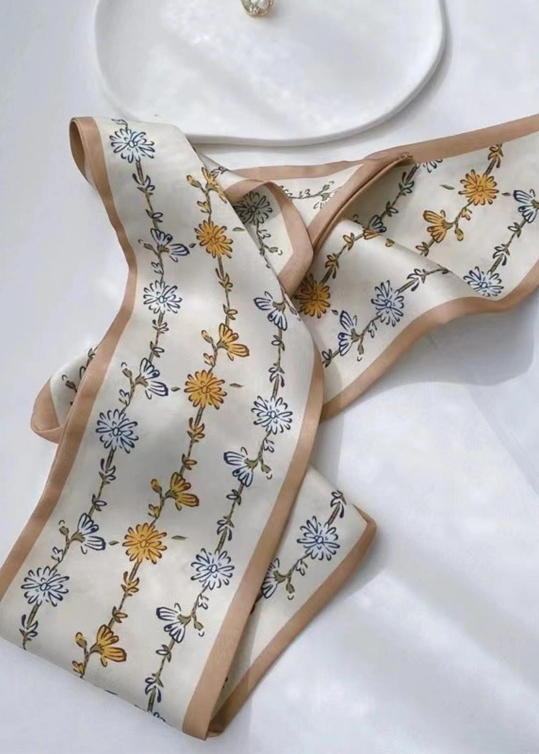 Taupe floral pattern scarf on a white background