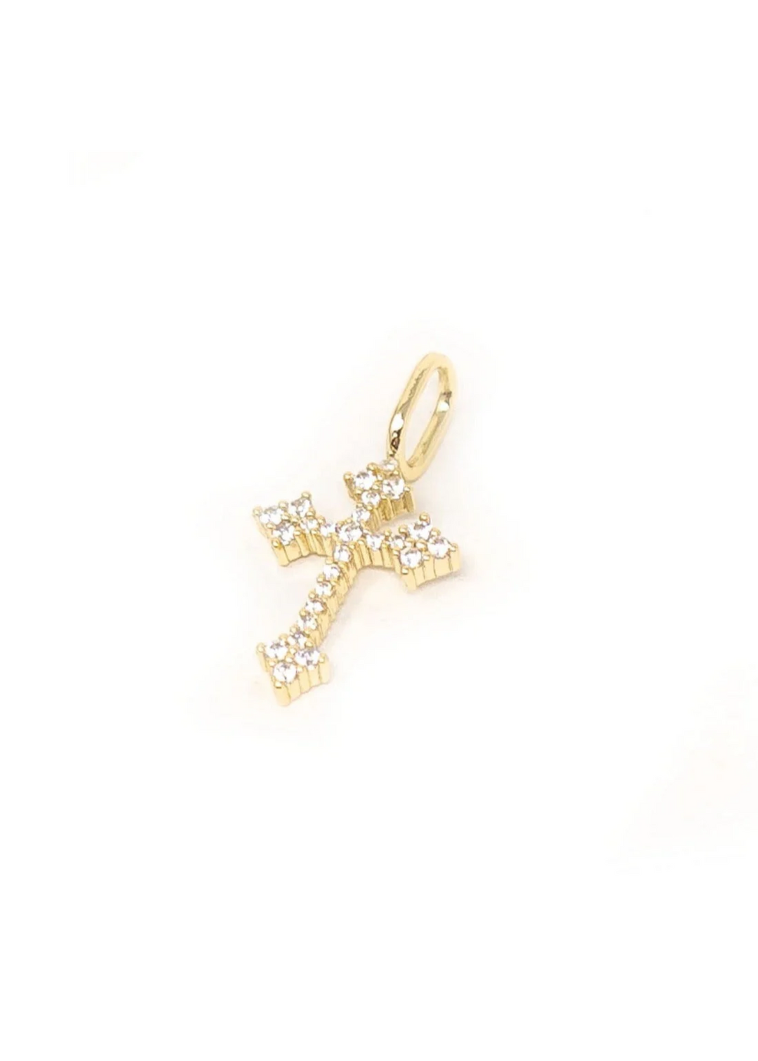 A gold cross charm with crystal details on a white background