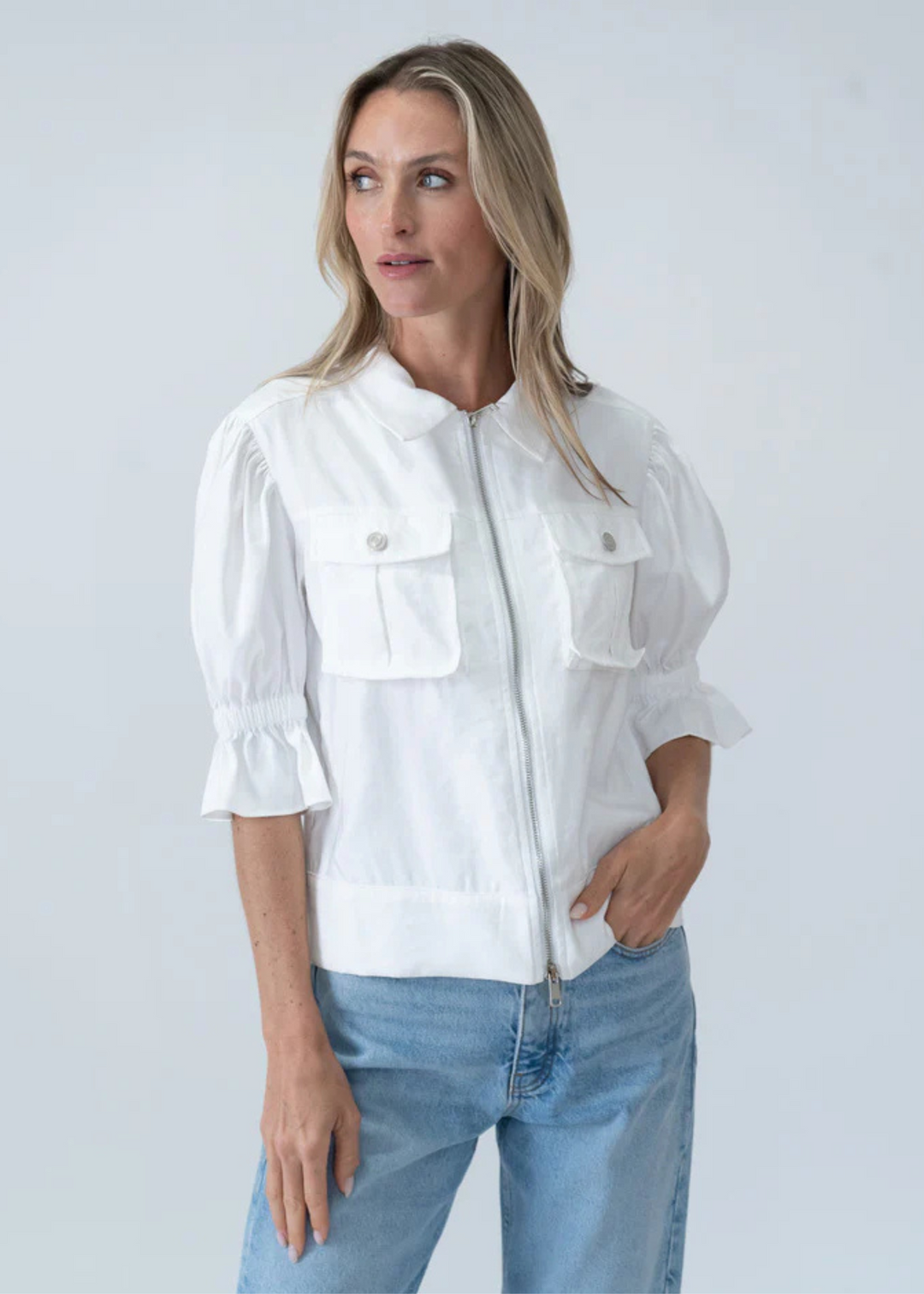 woman wearing white short puff sleeve collared zip up jacket