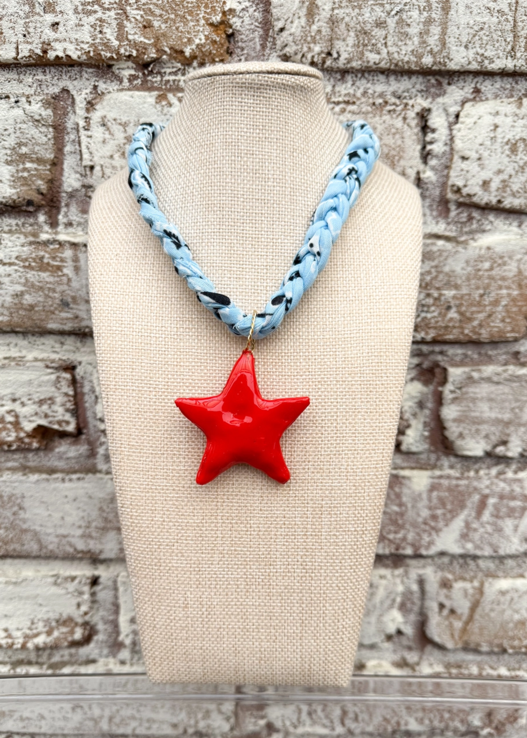 Powder blue bandana necklace with a large red star charm pendant
