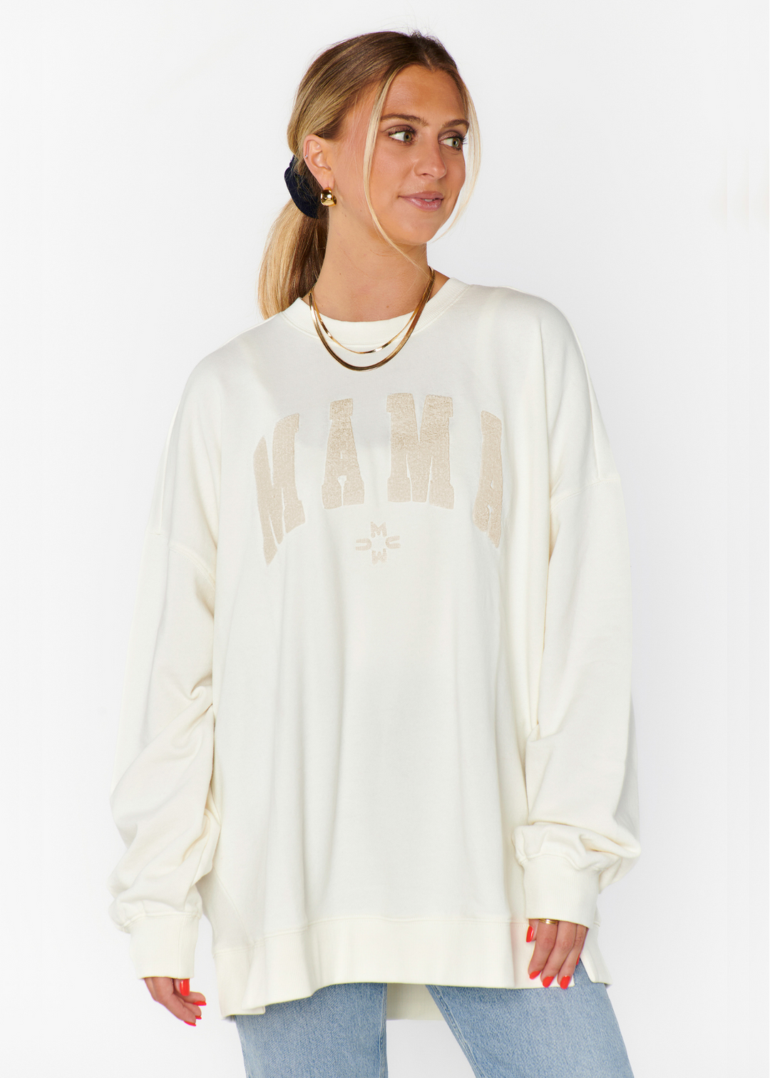 A woman wearing the Show Me Your Mumu Steve Sweatshirt in the Mama graphic in front of a white background