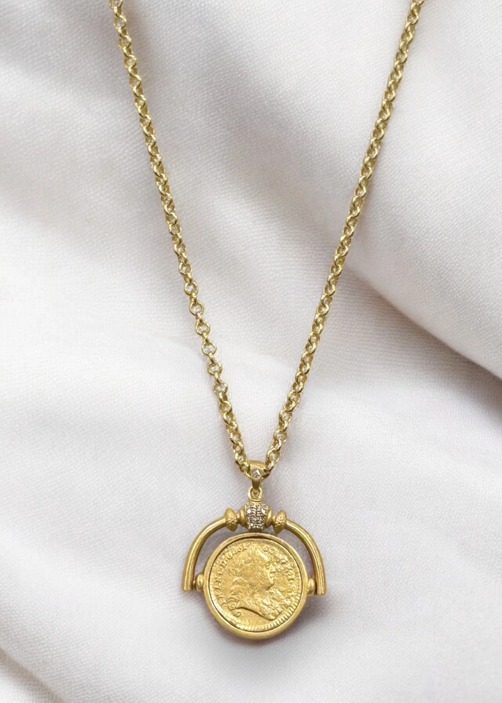 Gold necklace with a spinner and vintage coin pendant