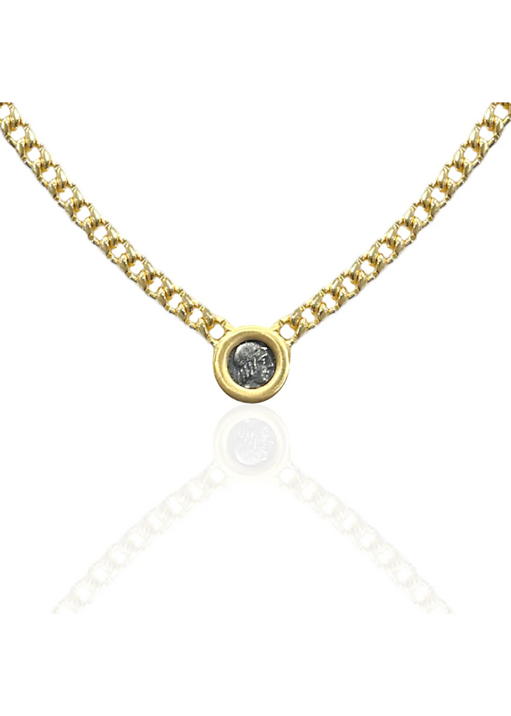 Gold chain necklace with a silver coin on a white background