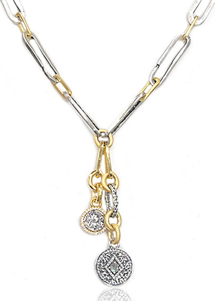 Gold and silver paperclip necklace with two charms on a white background