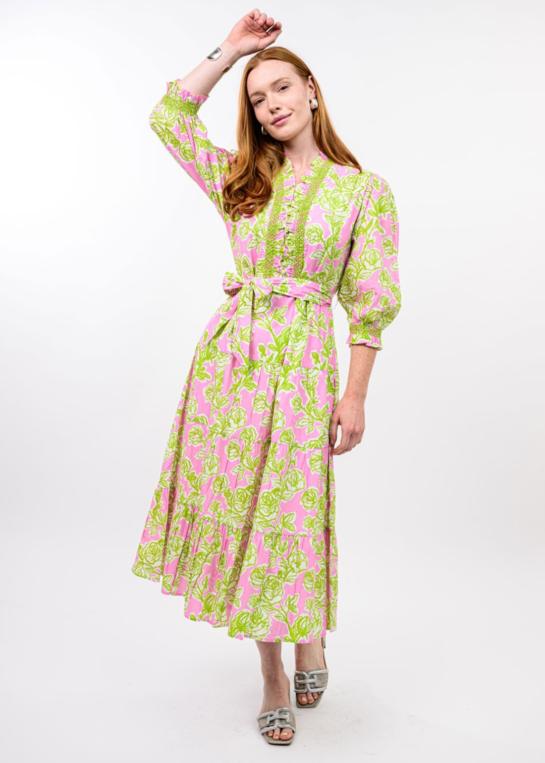 Woman wearing a pink and green floral midi dress