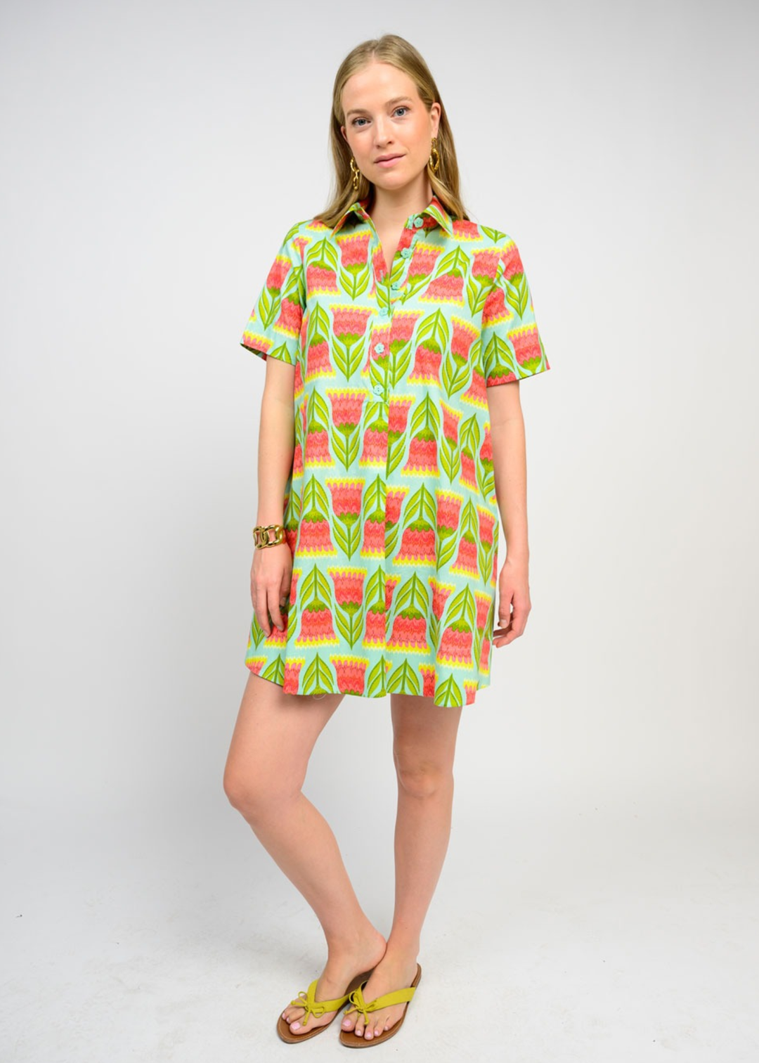 Woman wearing a blue, pink, and green tulip pattern mini dress