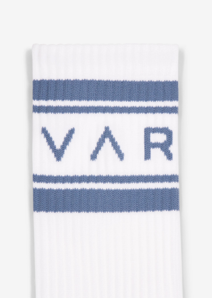 White crew socks with blue heels, stripes, and "VAR" lettering on a white background