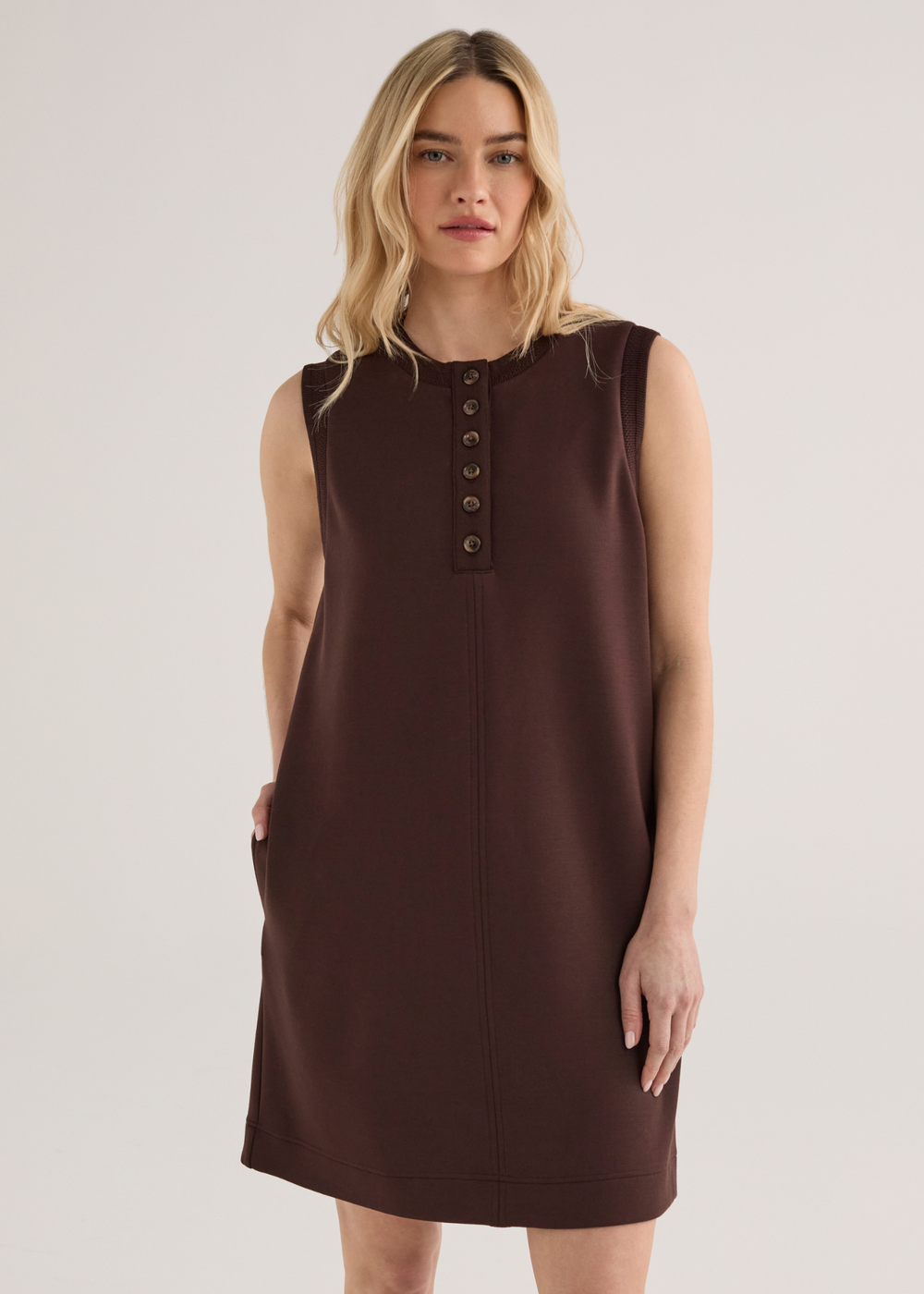 Woman wearing a brown sleeveless mini dress