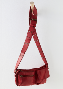 free people red leather crossbody sling back with 2 front pockets, interior pockets, and adjustable strap